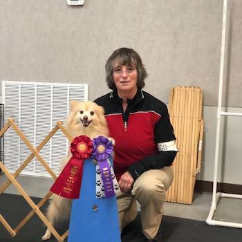 Mona with one of her dogs and his ribbons